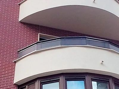 Un edificio de ladrillo con un balcón y una ventana.