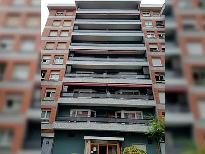 Un gran edificio de apartamentos con muchos balcones y ventanas.