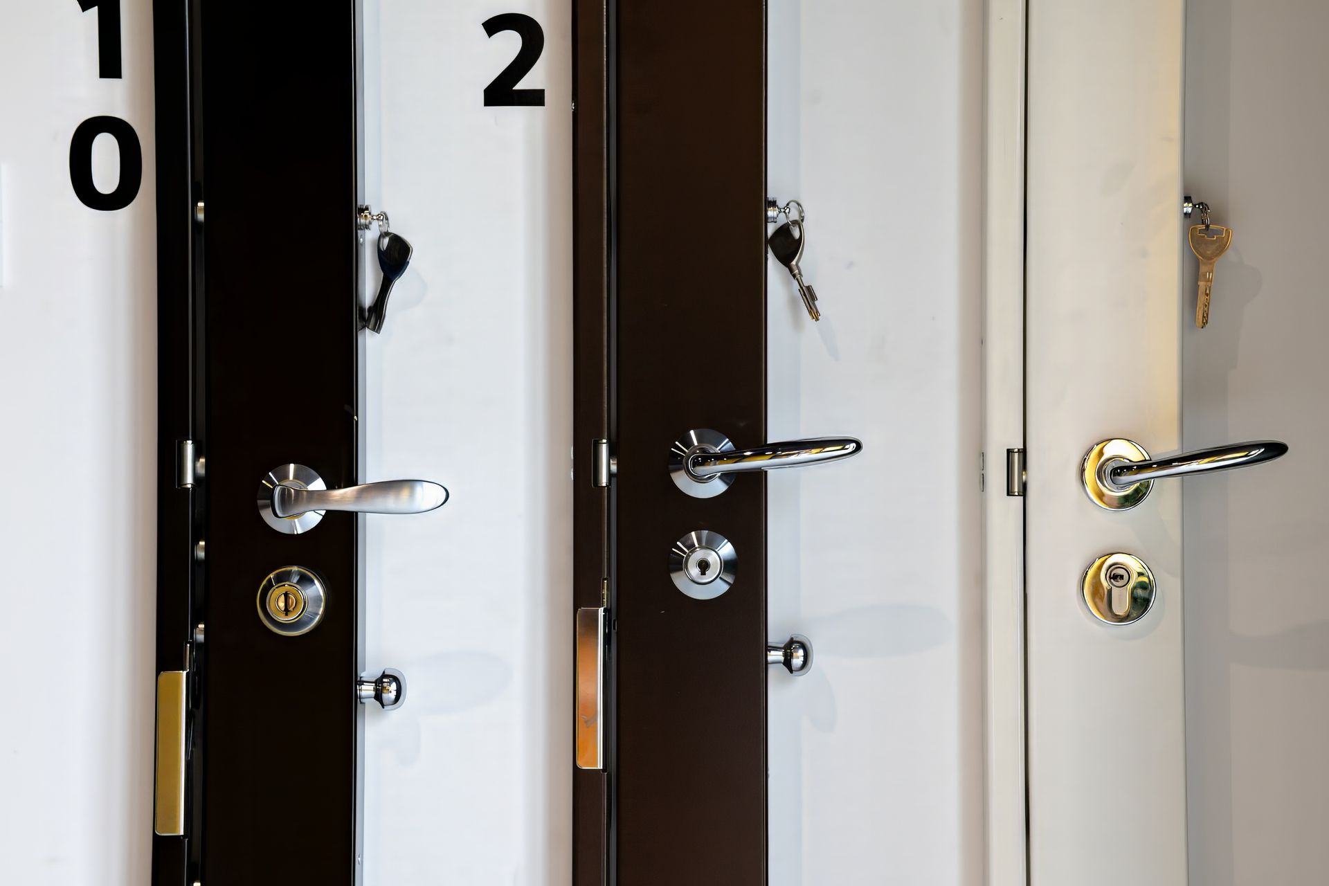 Trois portes différentes avec poignées métalliques et serrures.