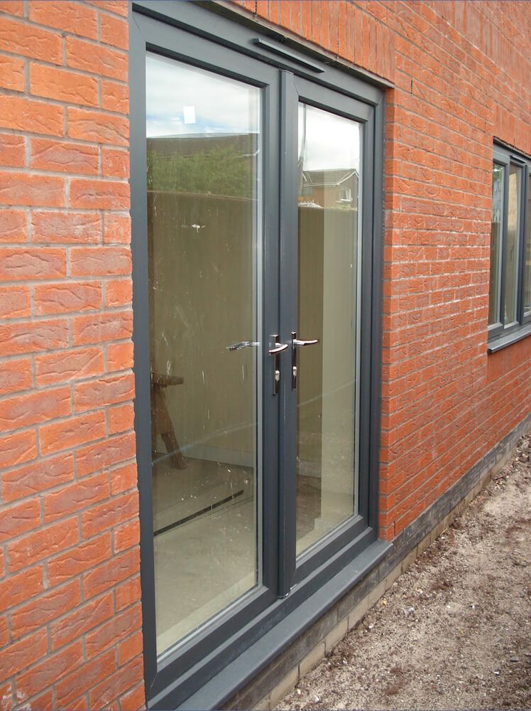 A brick building with a black door and windows