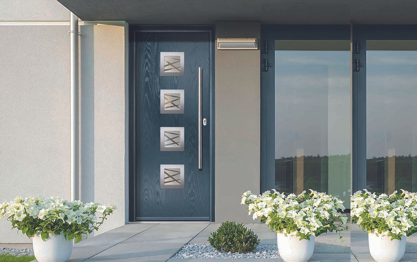 The front door of a house with flowers in front of it