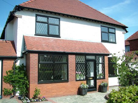 A white house with a red roof and black windows