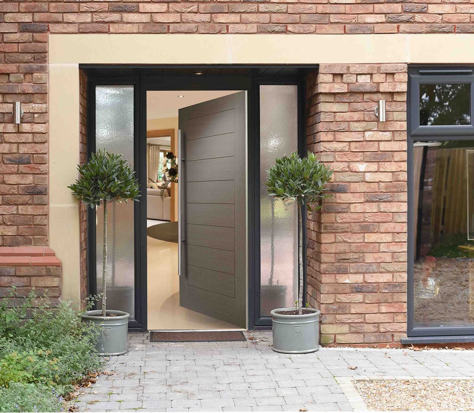 The front door of a brick house with a glass door
