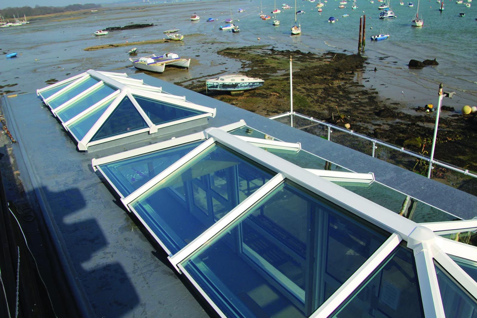 A roof with a view of a body of water with boats in it