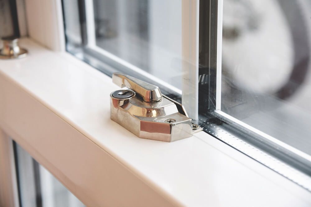 A close up of a window with a lock on it.