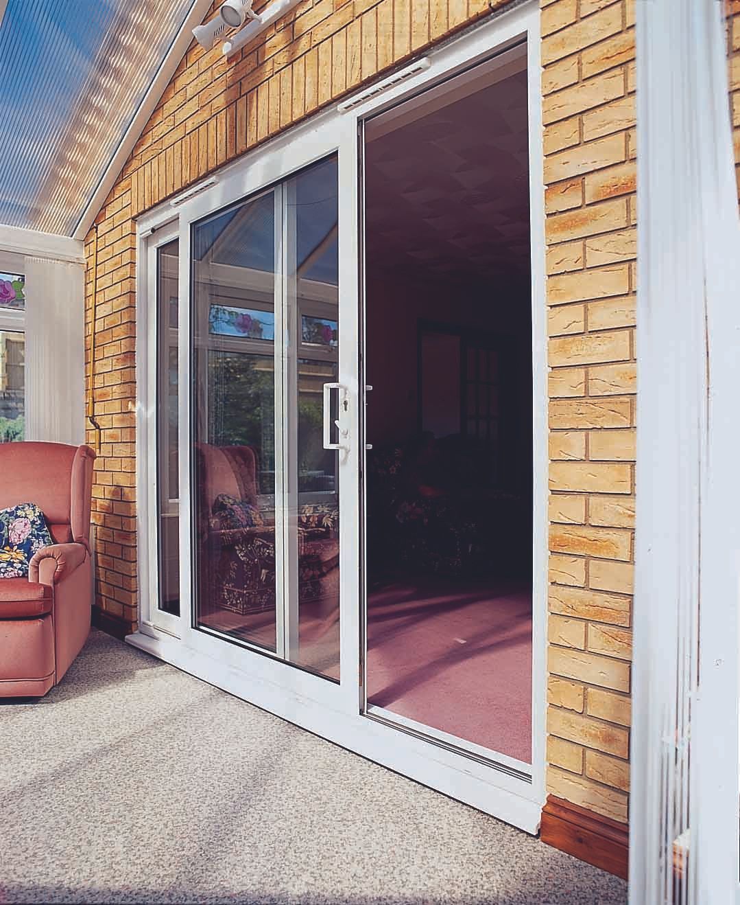 A living room with sliding glass doors and a chair