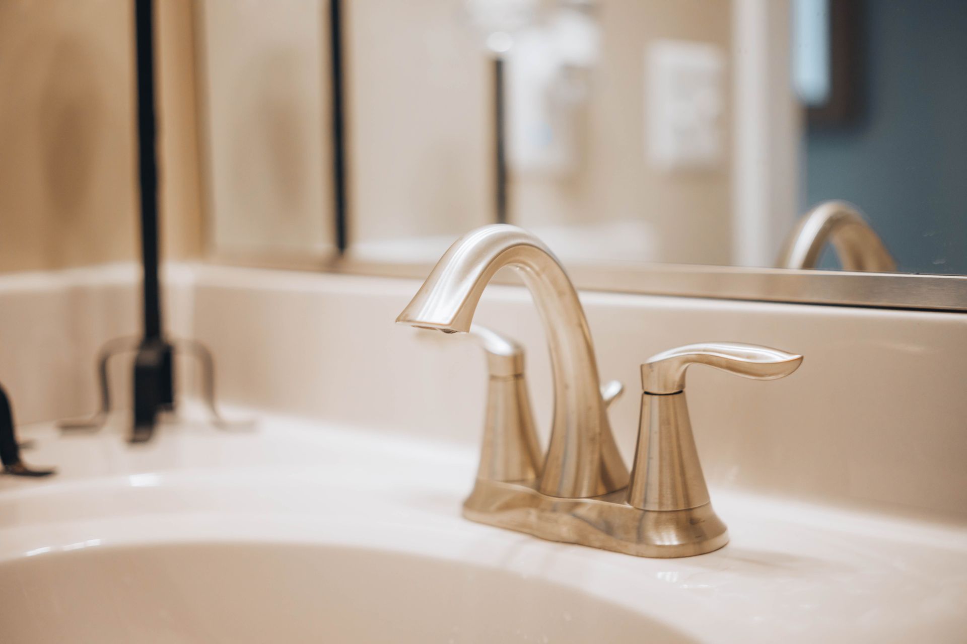 Lavabo de salle de bains avec robinet chromé et miroir beige sur le comptoir