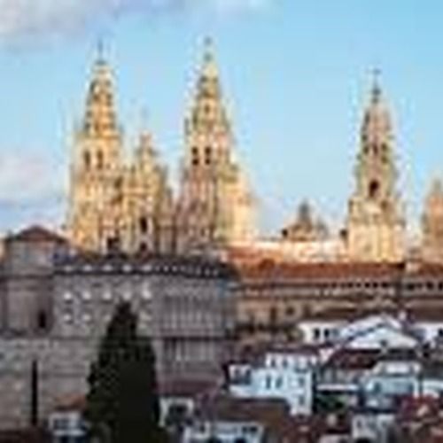Catedral con múltiples torres ornamentadas, sobre una ciudad bajo un cielo azul.