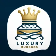 Logotipo de Luxury Burggos: corona dorada sobre una cama estilizada con el texto "LUXURY BURGGOS".