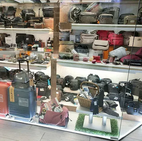 Una vitrina llena de maletas y bolsos en una tienda.