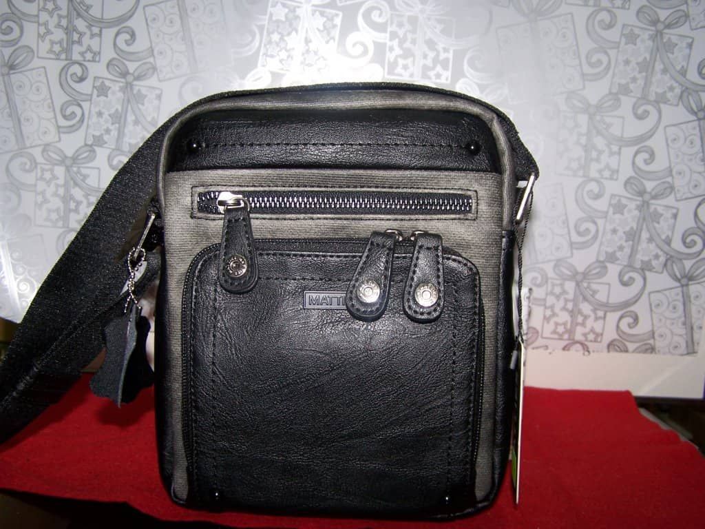 Un bolso de mensajero negro y gris con una etiqueta.