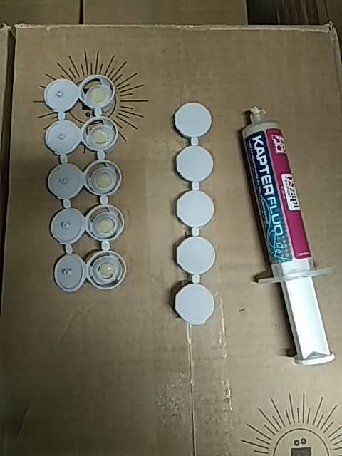 Une seringue est posée sur une boîte en carton.