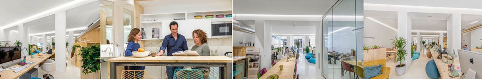 Una oficina luminosa y moderna con empleados que colaboran en una mesa y otros escritorios.