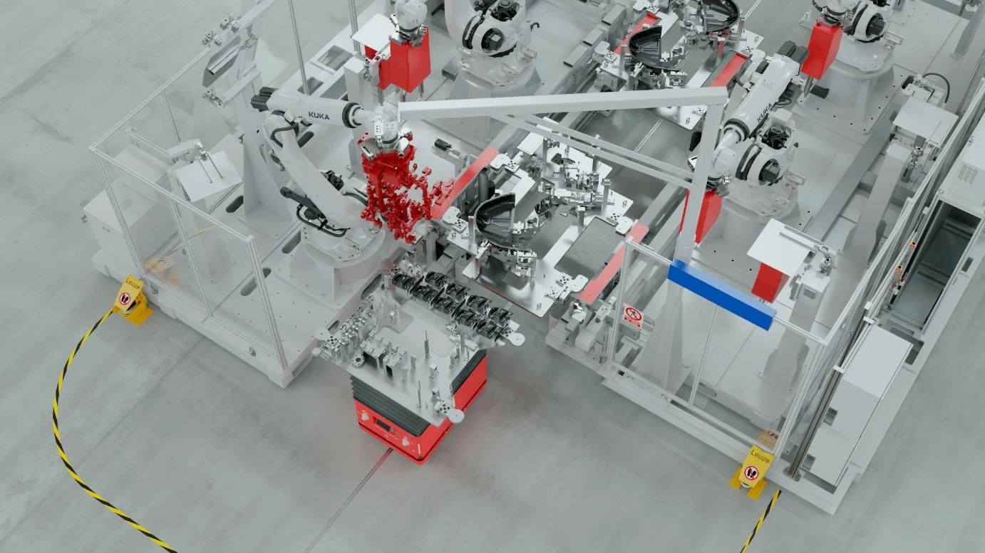 Una célula de fabricación robótica con un vehículo guiado automáticamente de color rojo