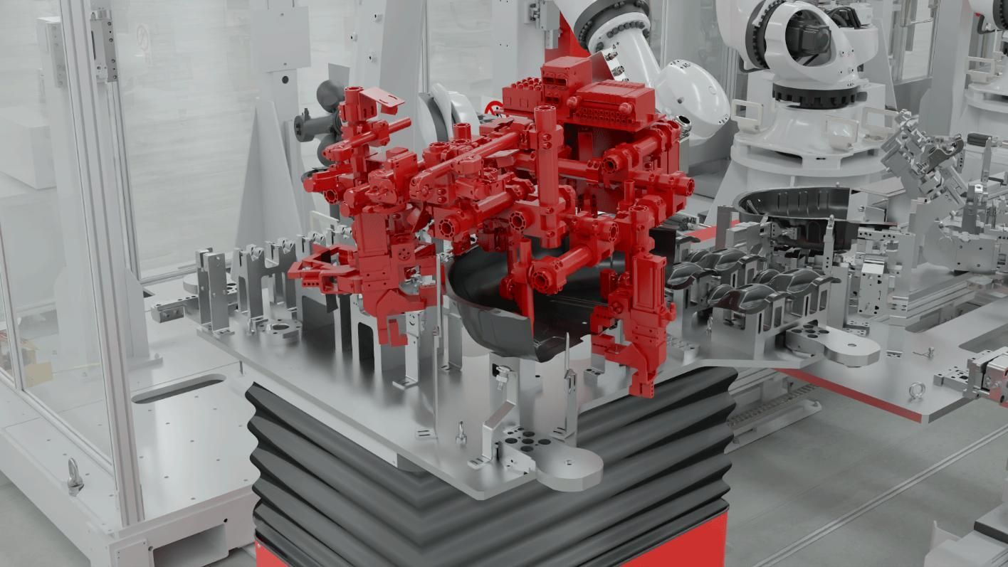 Luminaria industrial roja montada sobre una base negra en una fábrica, con equipos robóticos al fondo.