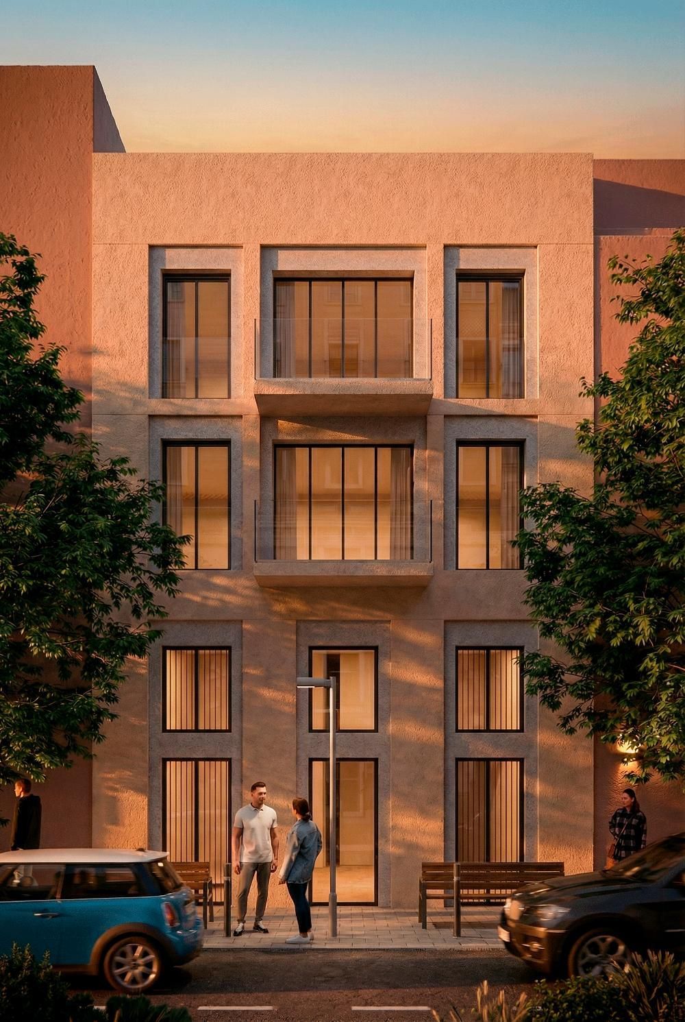 Vista exterior de un moderno edificio de apartamentos de piedra de varias plantas al atardecer
