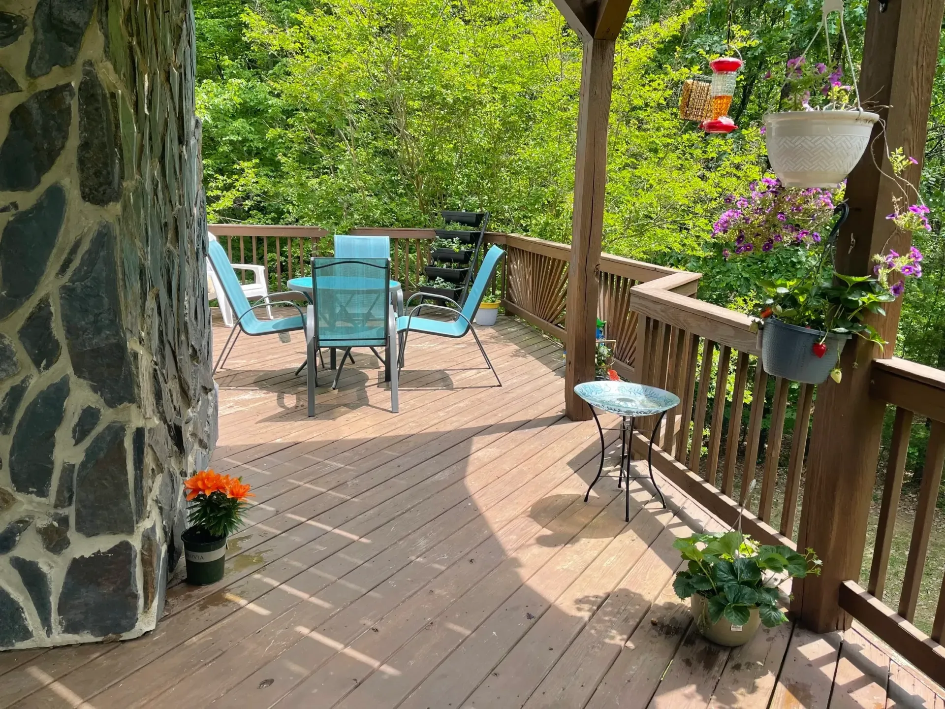 A wooden deck with a table and chairs on it