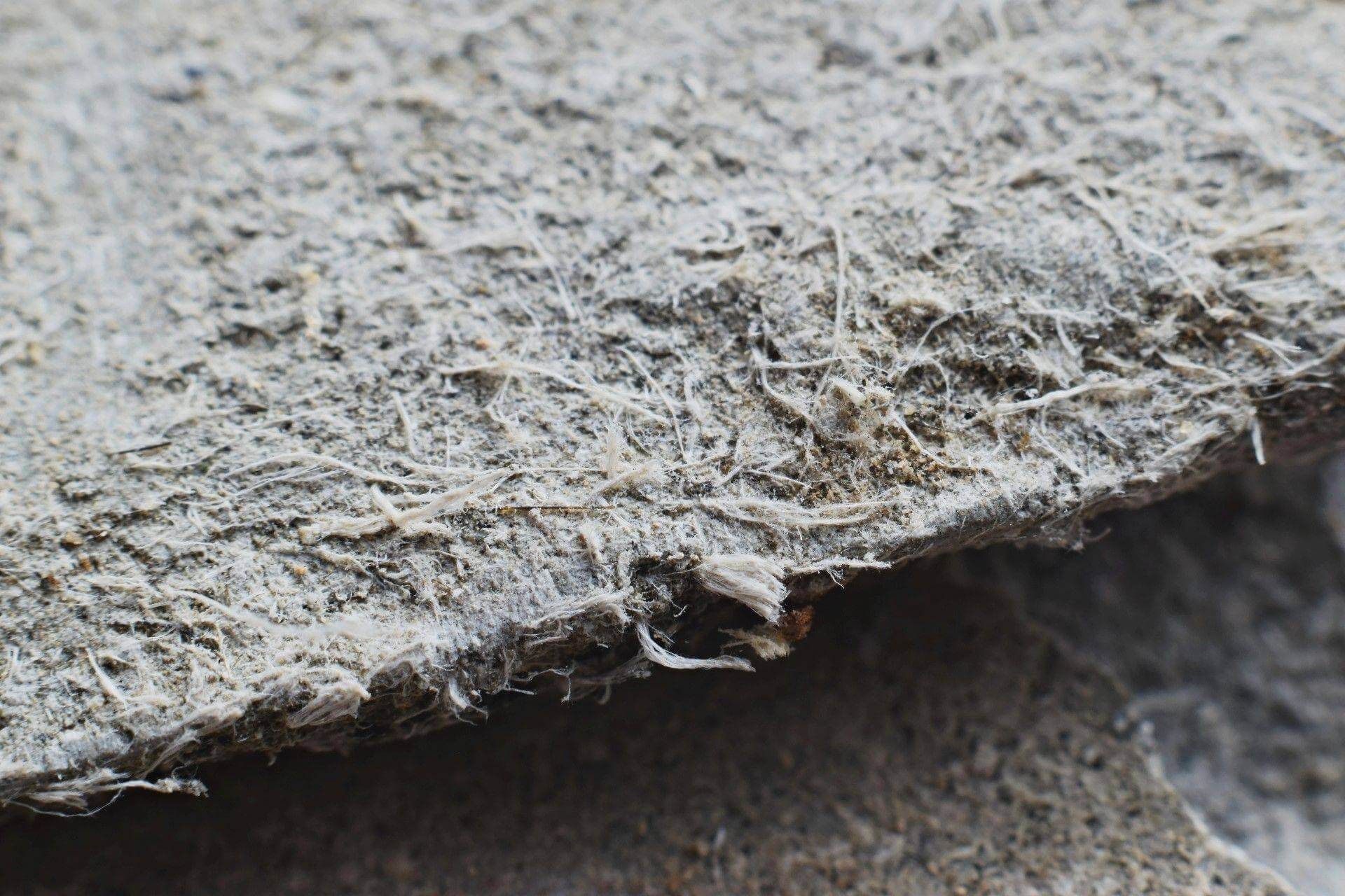 Close-up of gray, fibrous material; possibly asbestos.