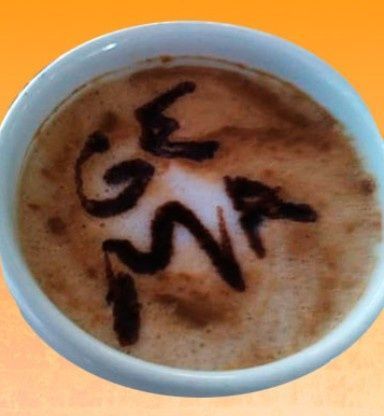 Taza de café con arte latte que dice 