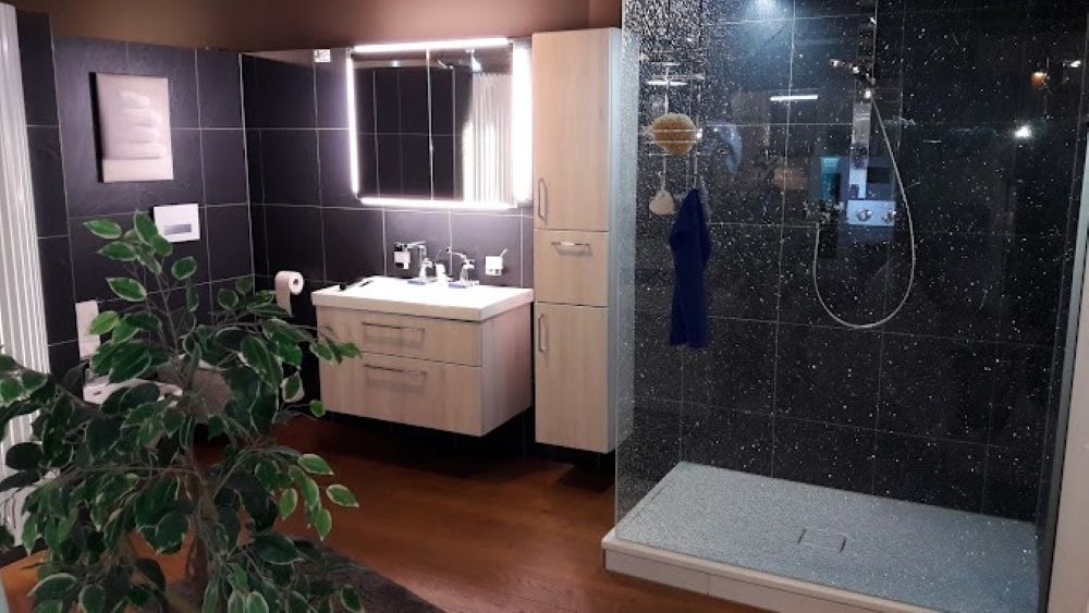 Ein Badezimmer mit Waschbecken und ebenerdiger Dusche.