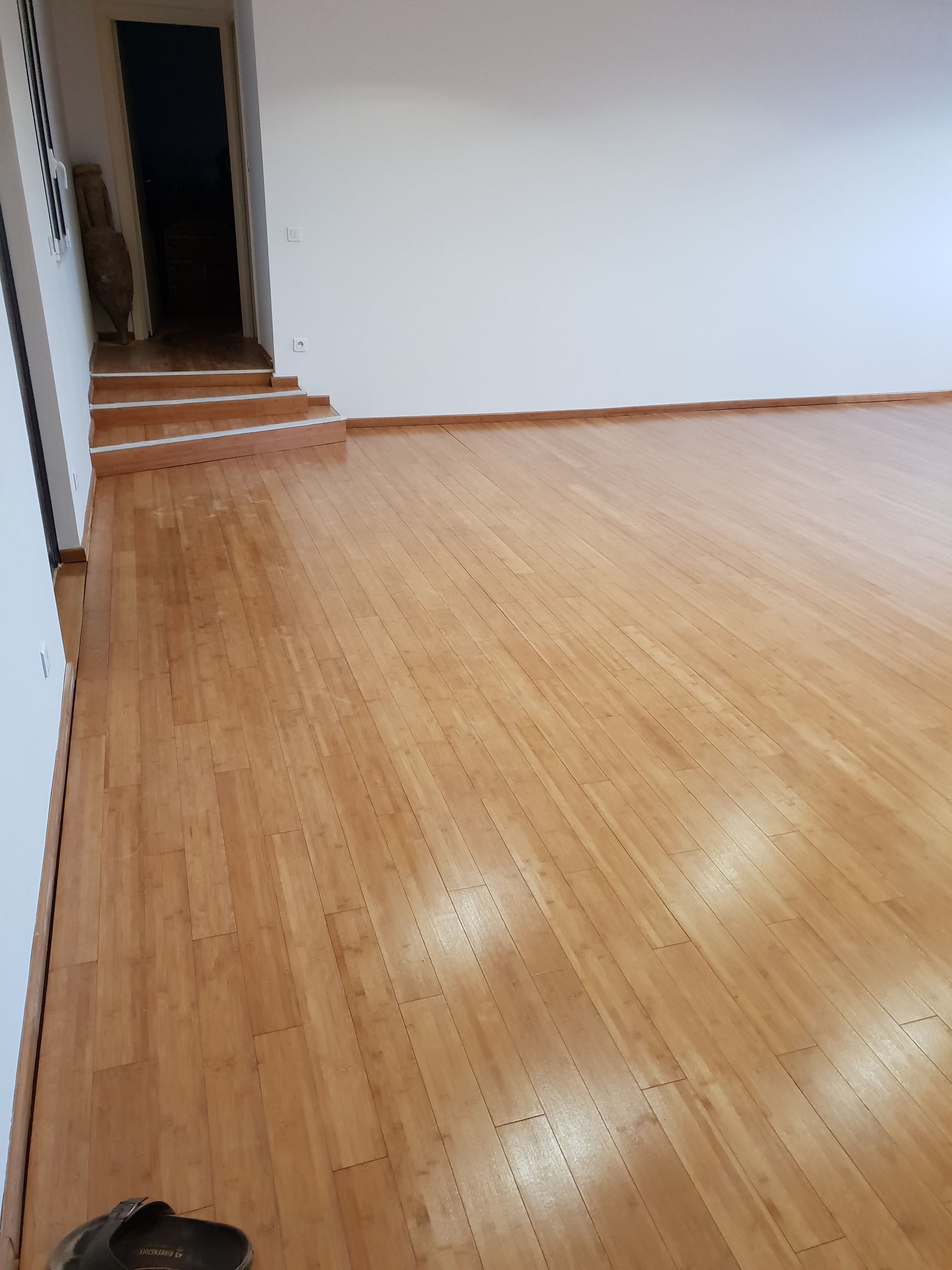 Parquet à l'anglaise rénové dans une grande pièce avec trois marches
