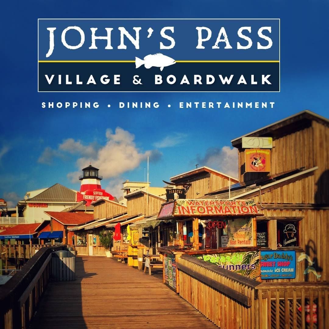 John's Pass Village & Boardwalk, a shopping and dining area with wooden buildings and walkways near the water.