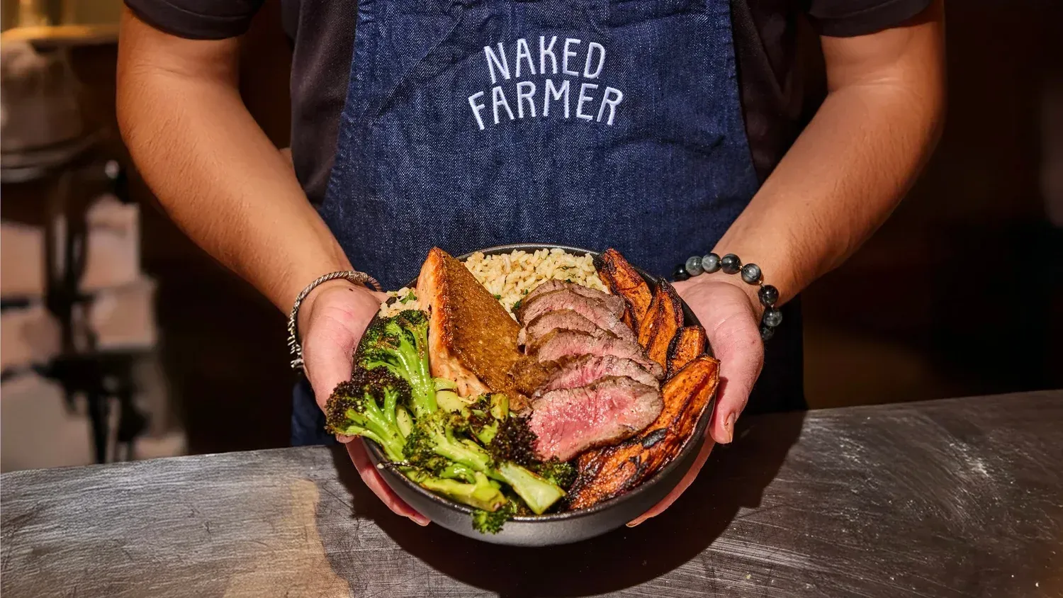 Person holding a bowl of food from