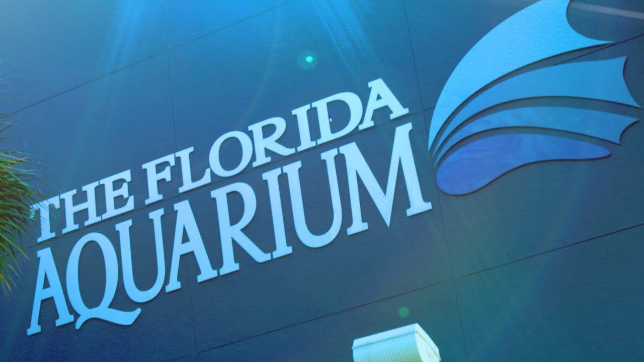 Sign for The Florida Aquarium, with blue background and logo.