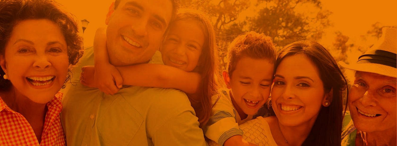 Familia sonriendo junta al aire libre.