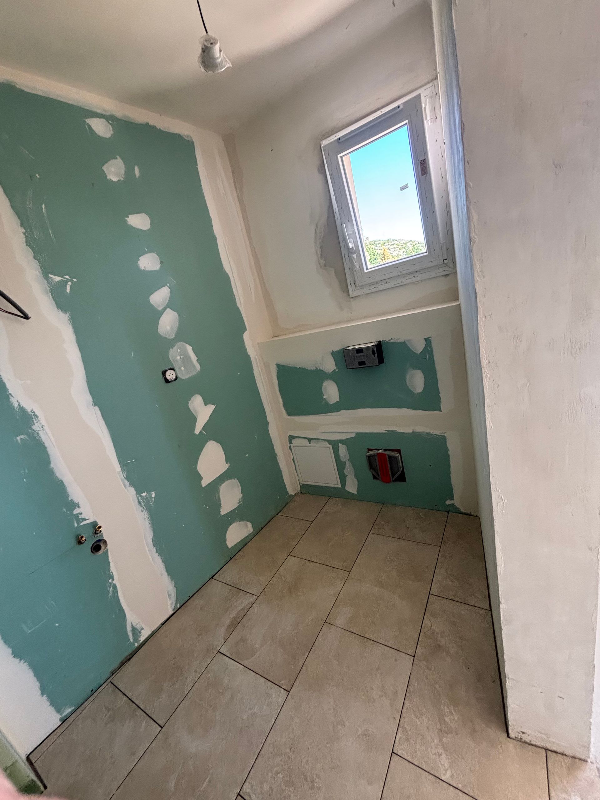 Petite salle de bains en rénovation avec des plaques de plâtre hydrofuge.