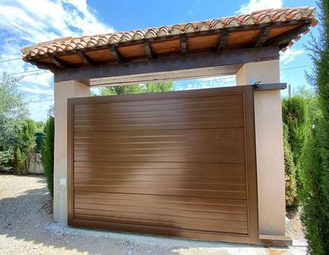 Una puerta de madera con techo de tejas se encuentra junto a una pared.