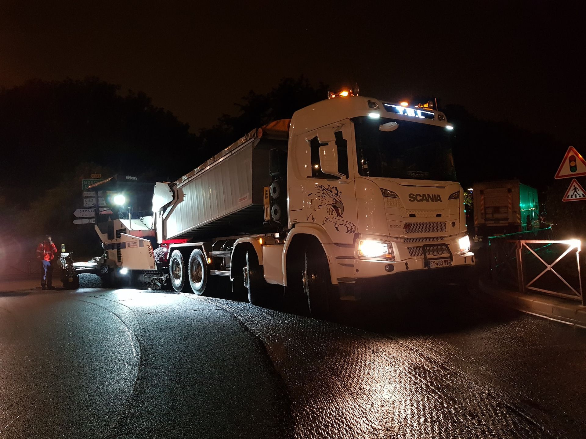 Camion-benne de nuit sur un rond point