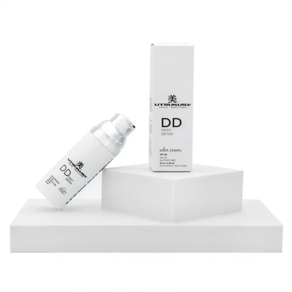 Botellas de productos para el cuidado de la piel de color blanco, una de ellas colocada 