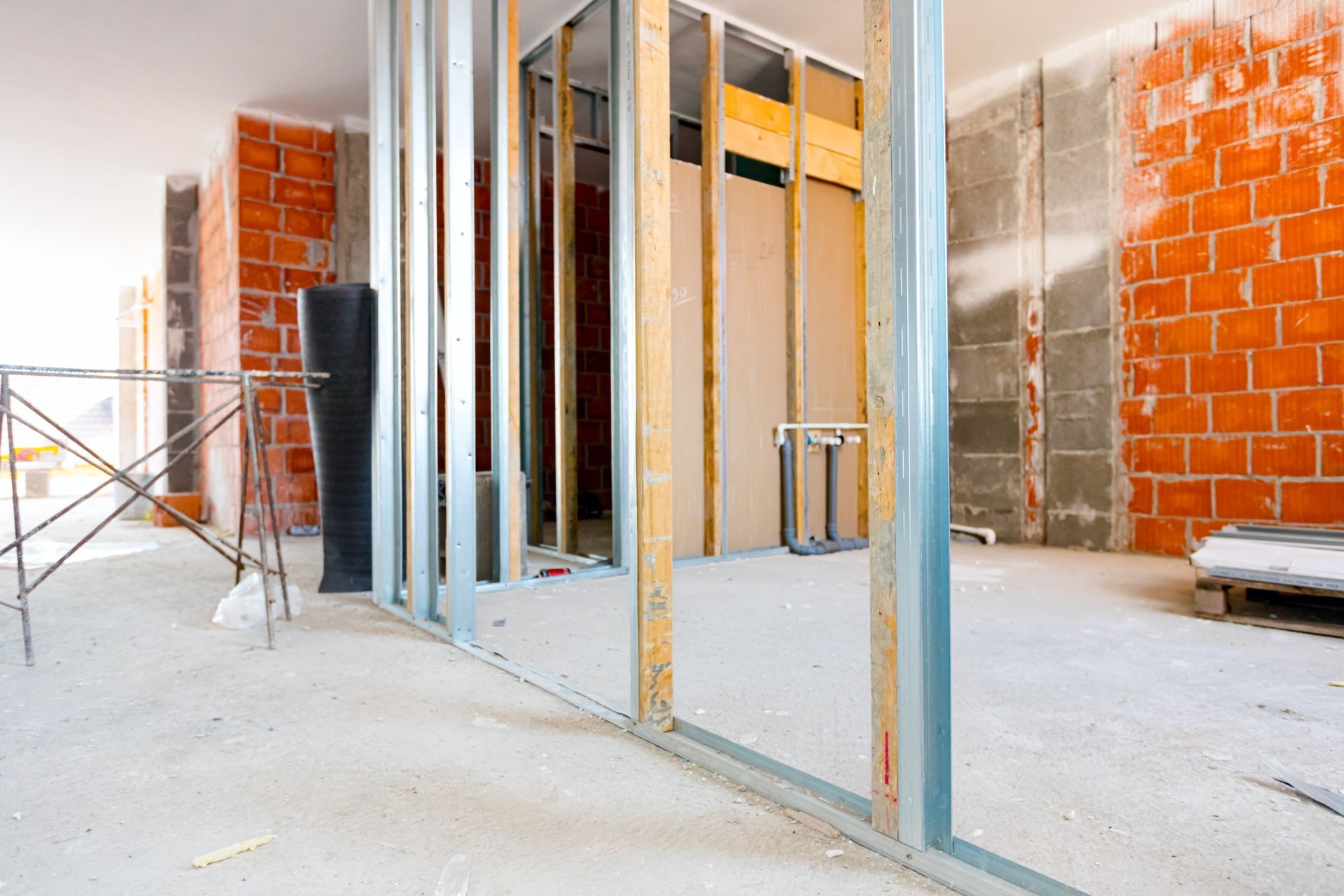 Una habitación en construcción con paredes de ladrillo y marcos de metal.