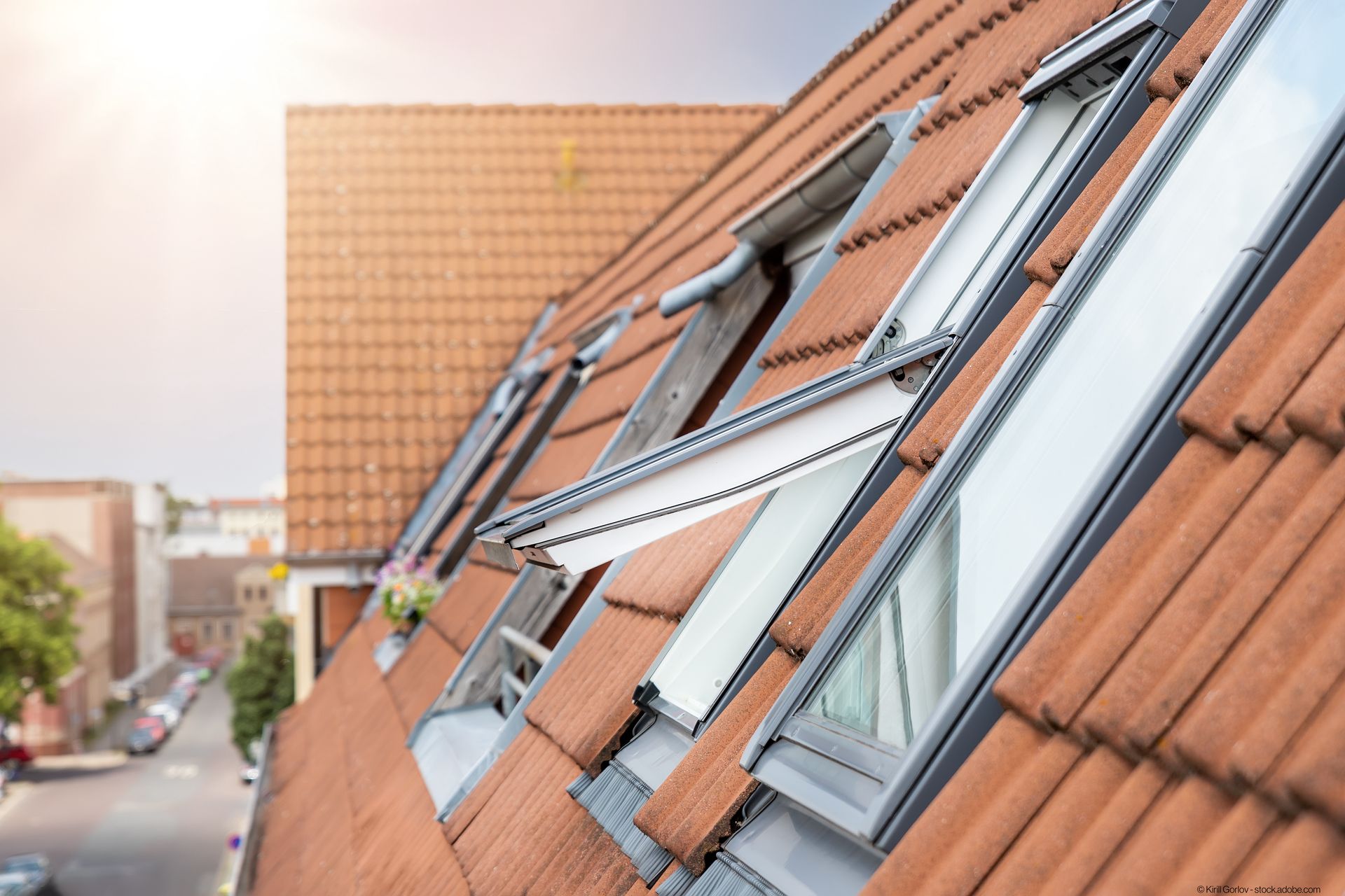 ein Dachfenster öffnet sich auf einem roten Dach