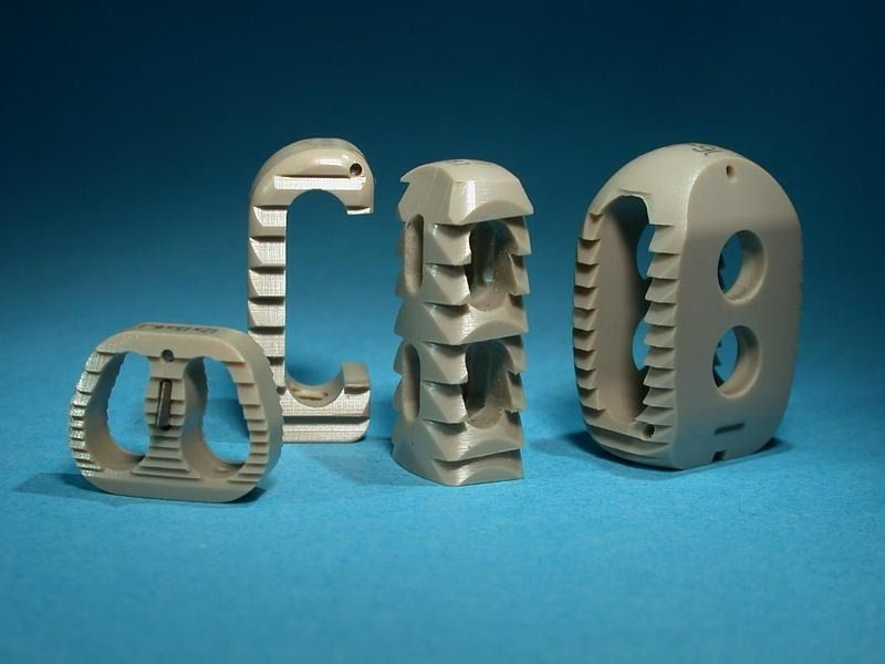 Quatre lettres et formes beiges imprimées en 3D sur fond bleu