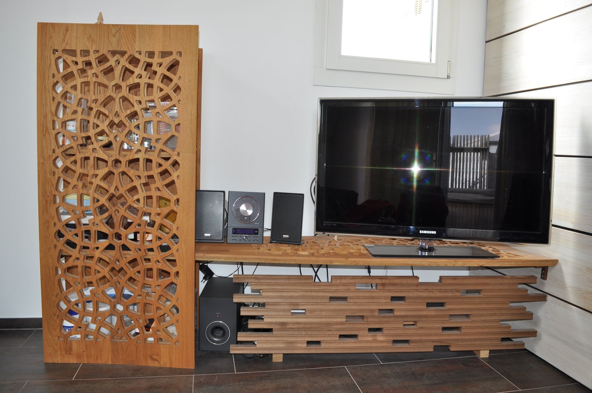 A flat screen tv is sitting on a wooden entertainment center
