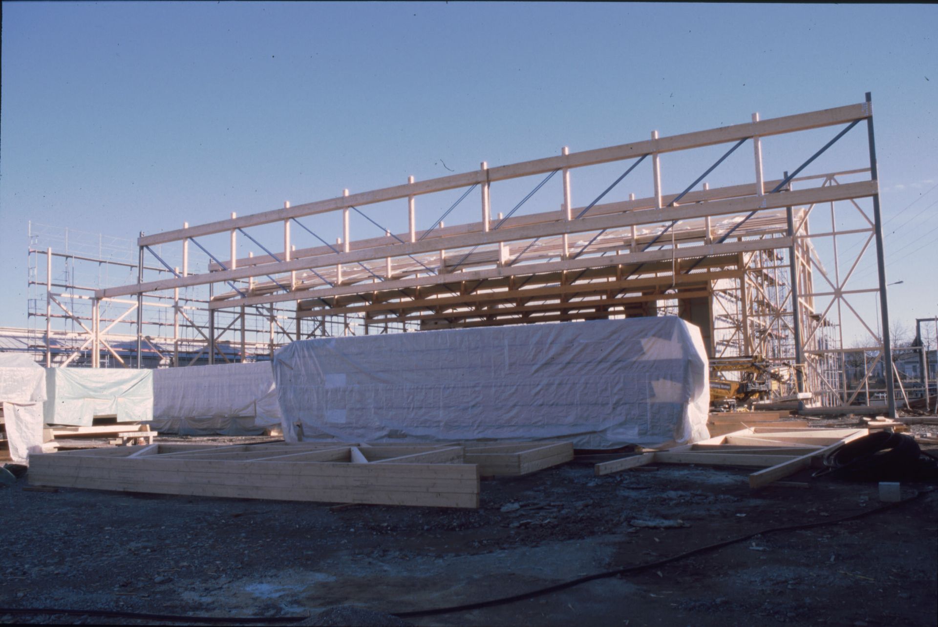A building under construction with a blue sky in the background