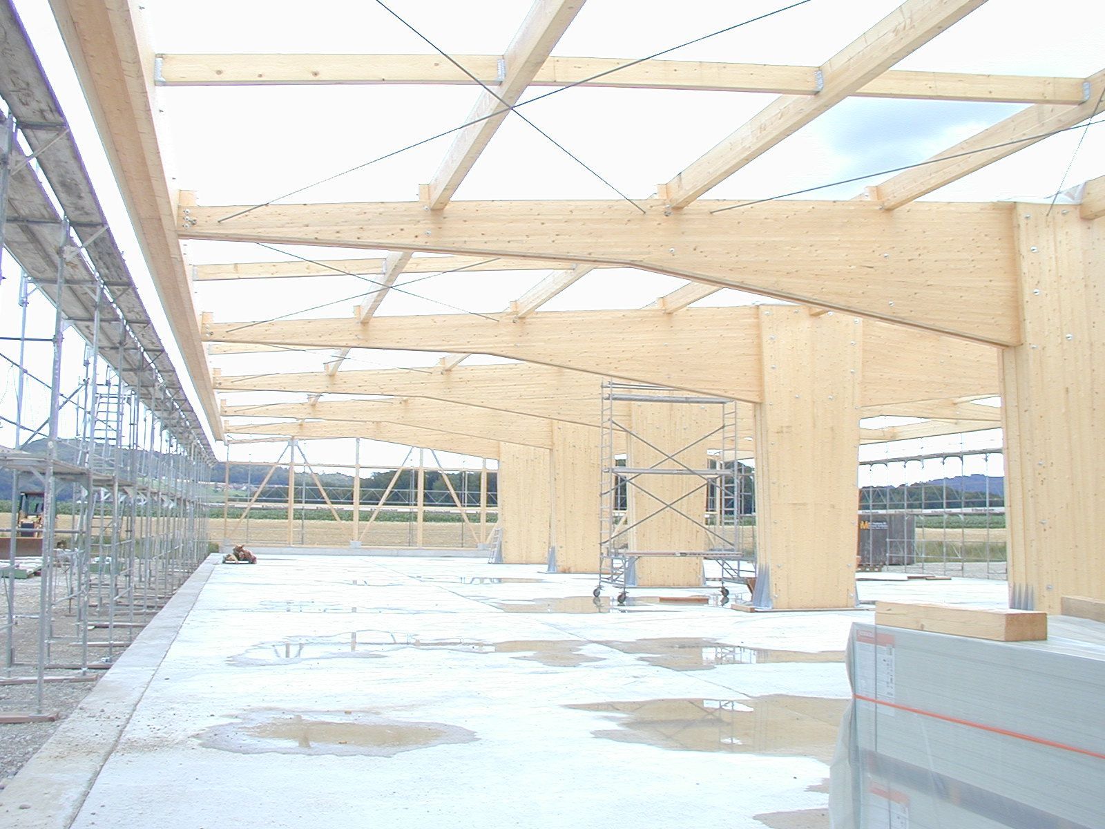 A building under construction with wooden beams and scaffolding