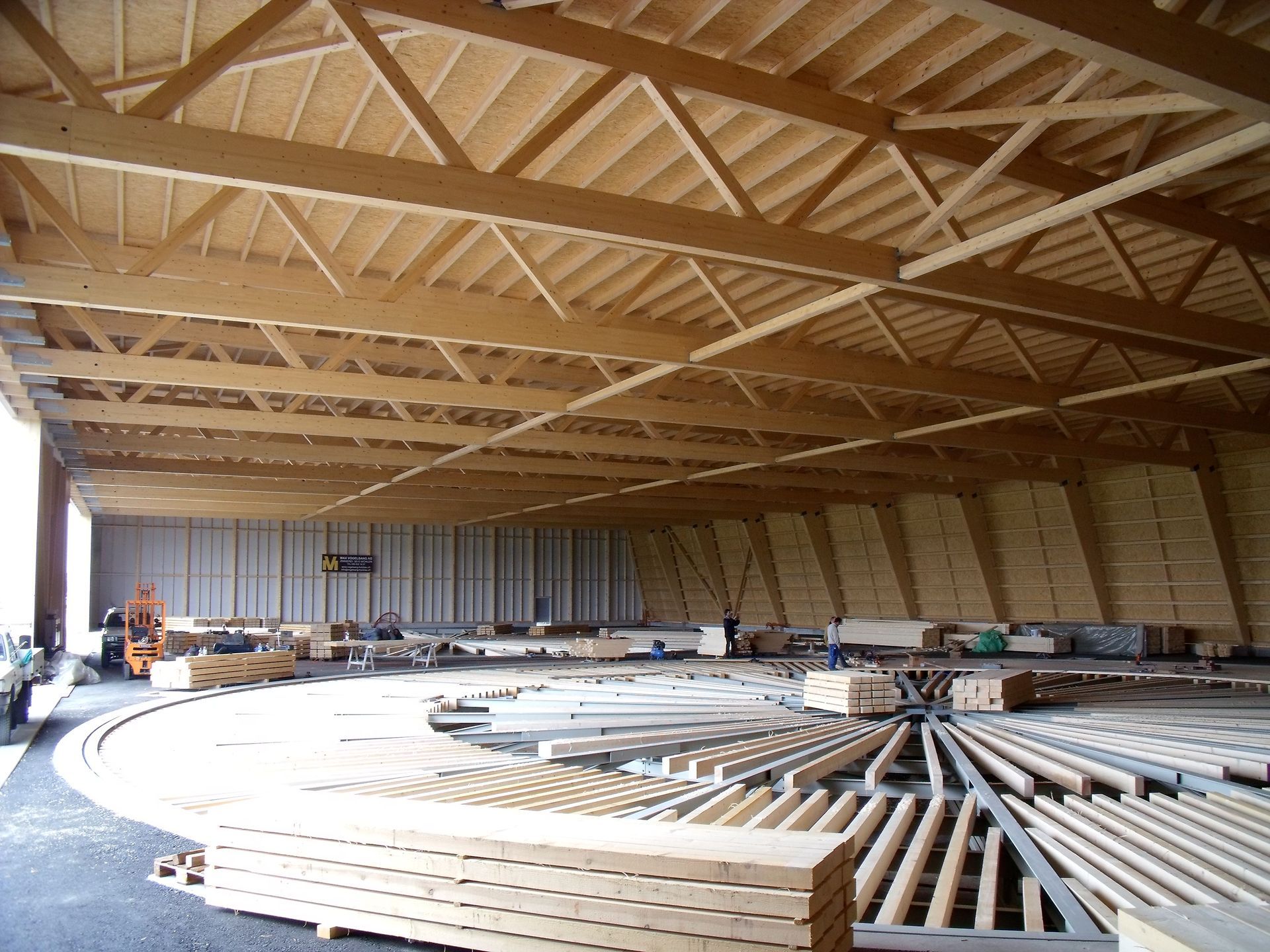 A large warehouse filled with wooden beams and pallets