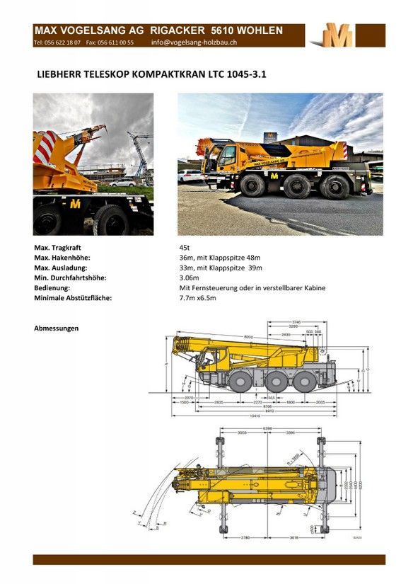 A yellow truck with a crane attached to it is parked on the side of the road.