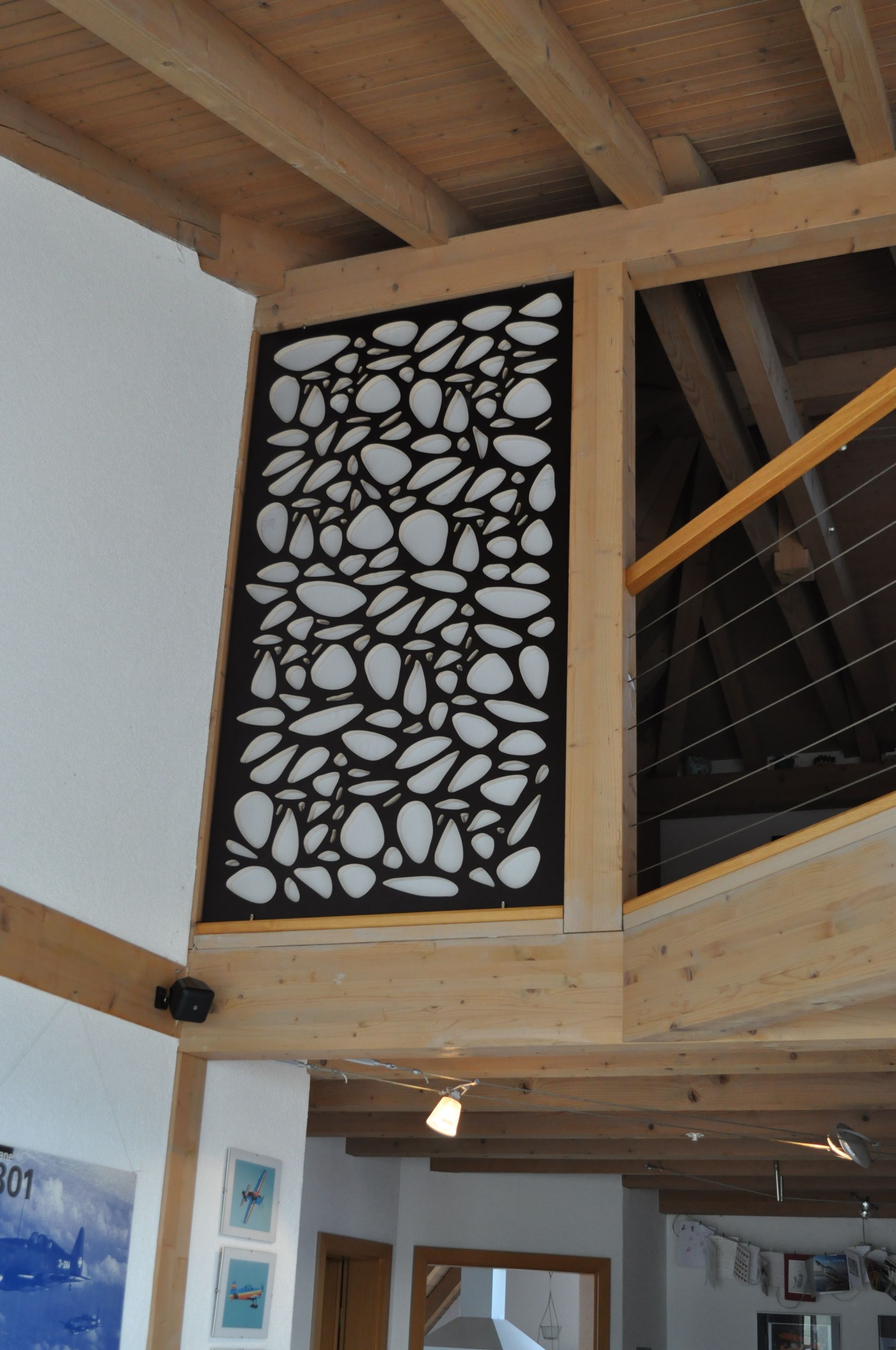 A room with a staircase and a wall with a pattern on it