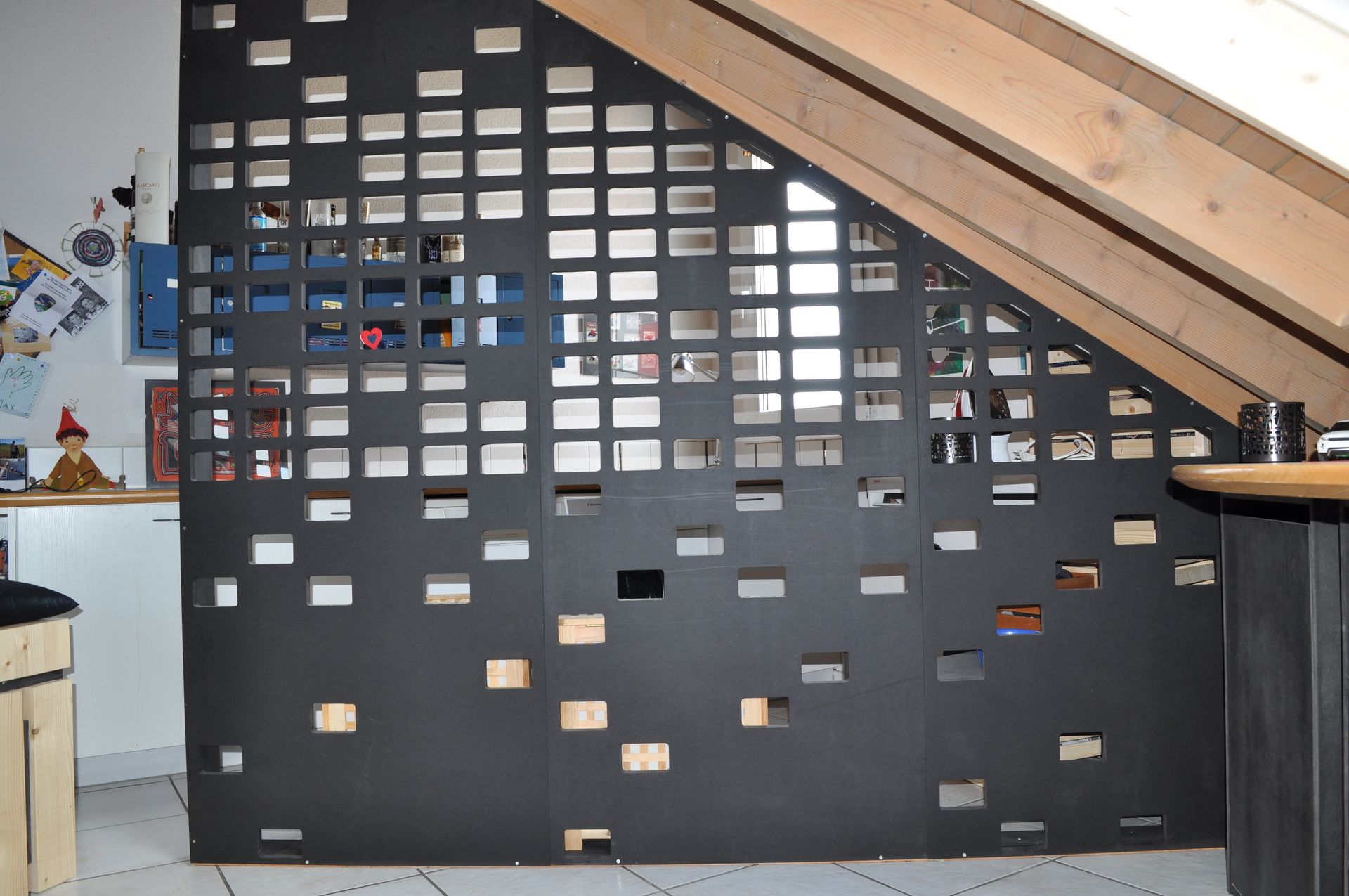 A room with a wall that has a lot of squares on it