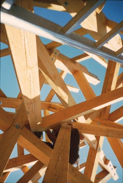 Looking up at a wooden structure with a blue sky in the background