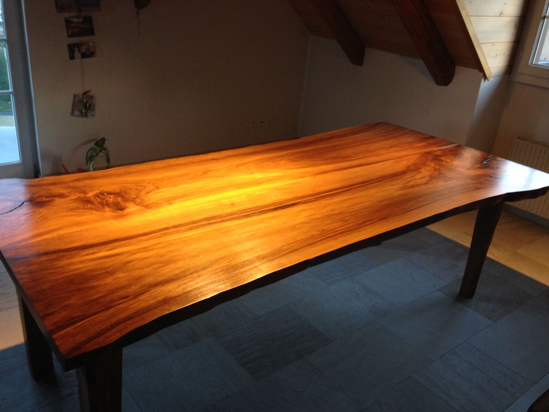 A wooden table is sitting on a rug in a room