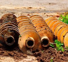 Un montón de vasijas de barro colocadas encima de un montón de tierra.