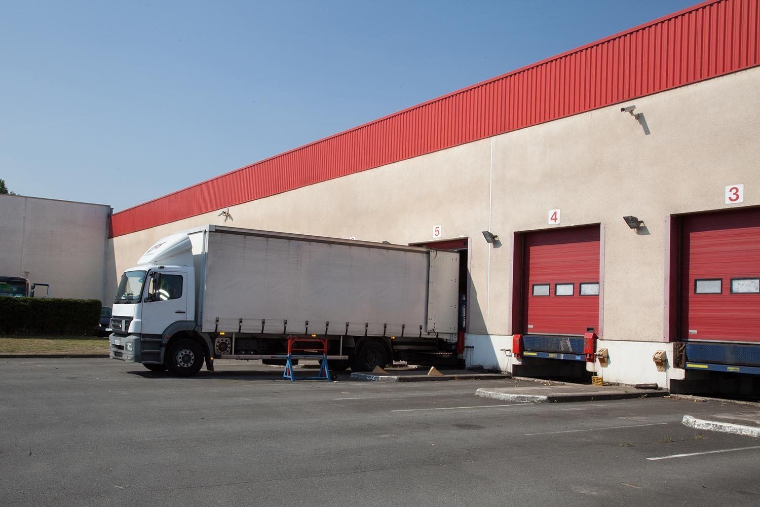 Camion qui décharge sa marchandise sur un quai d'entrepôt