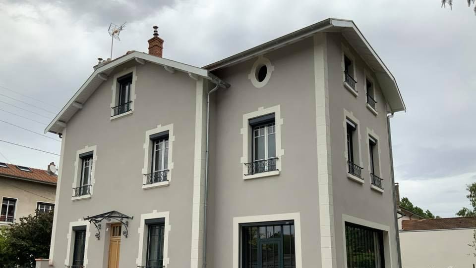 Maison avec une finition grattée fine en gris souris G30 et des modénatures blanches ajoutées