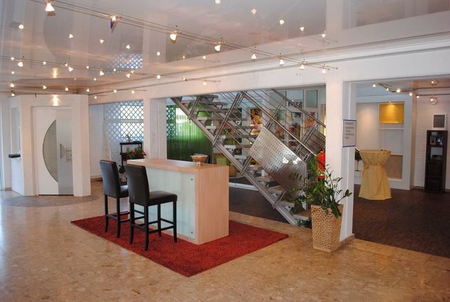 Brenig Instandsetzungs GmbH – Ausstellungsraum mit Minibar und Treppe im Hintergrund