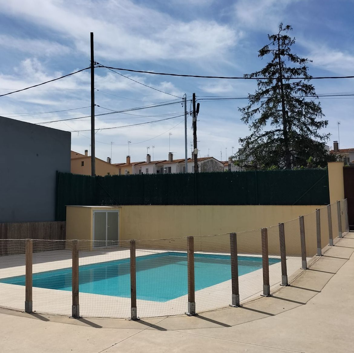 Una gran piscina rodeada por una valla de madera.